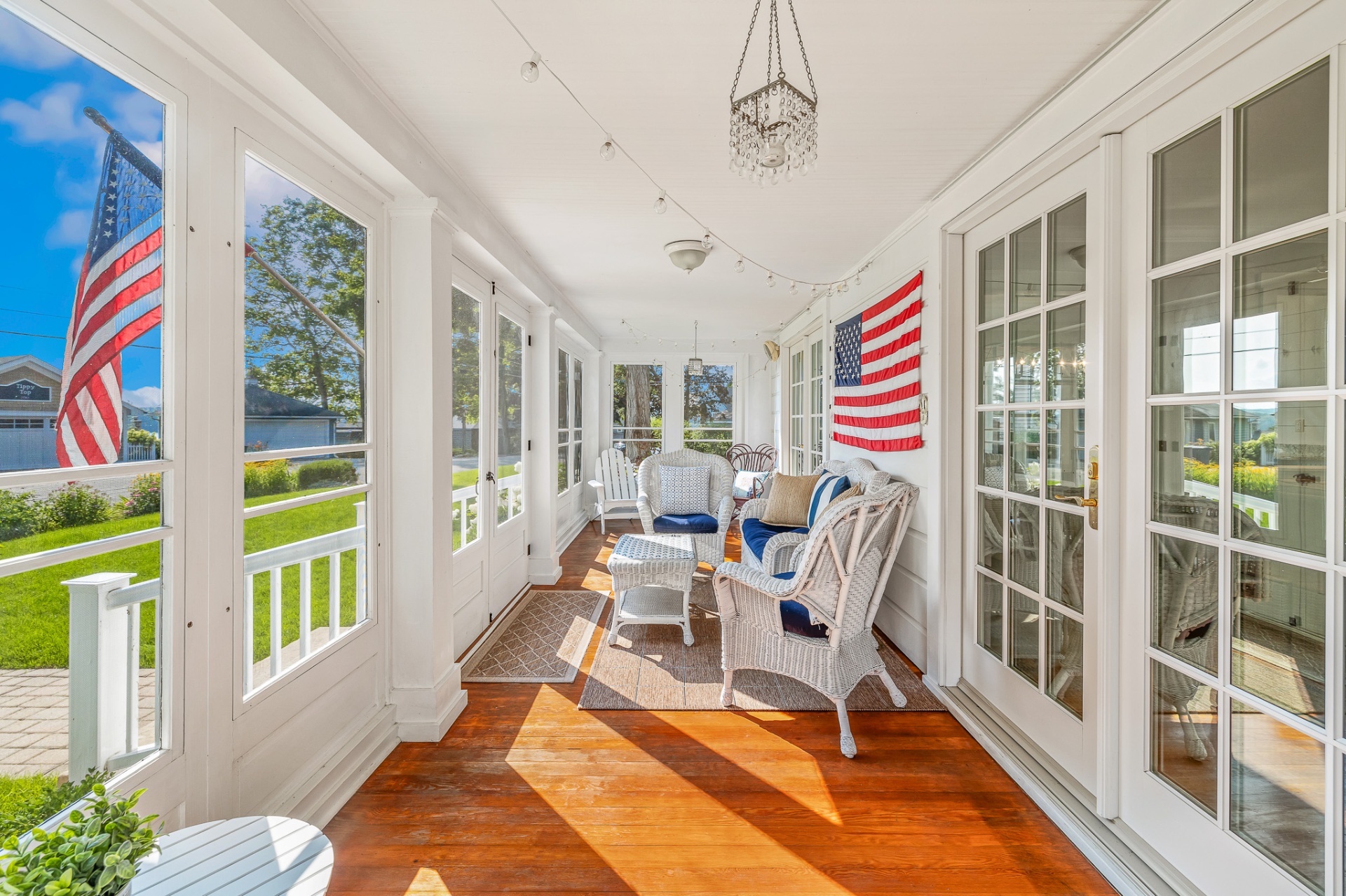 Sunlit screened porch with wood floors