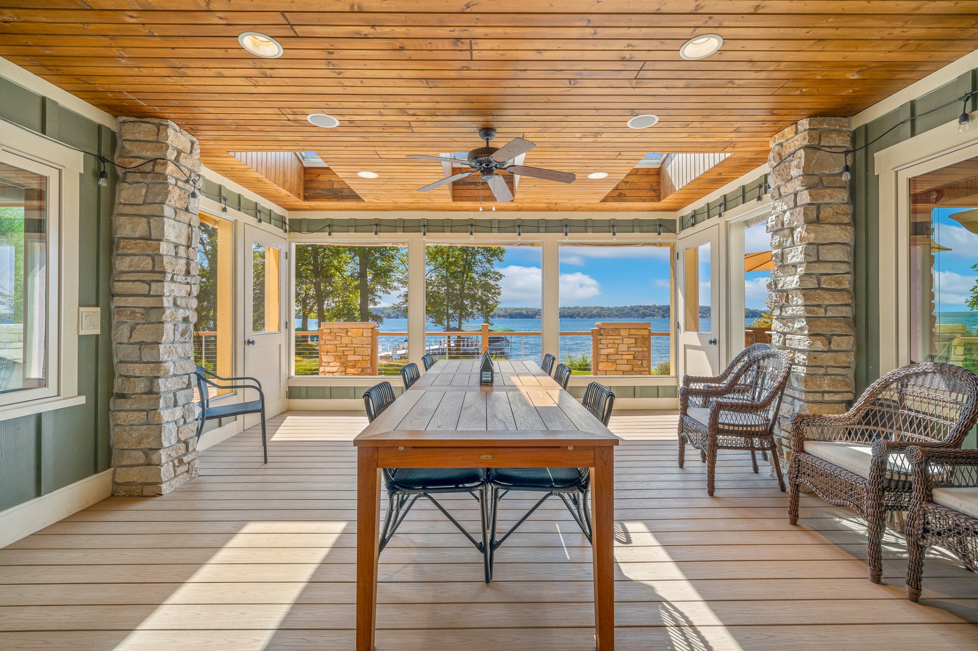Covered lakeside porch with stone columns