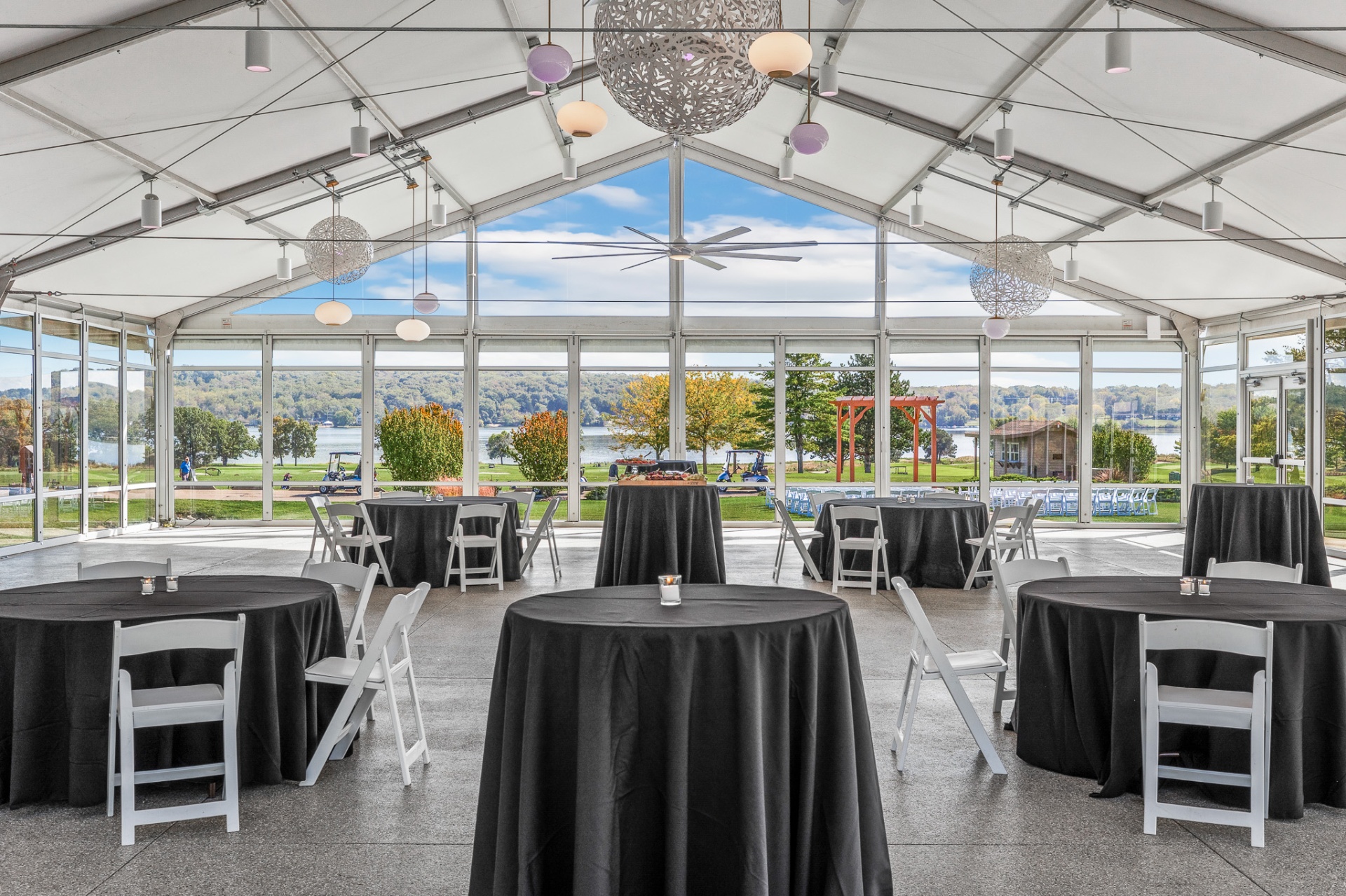 Glass-walled tented pavilion overlooking the lake